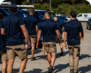 Plumbers walking to their service vans on a Sydenham job