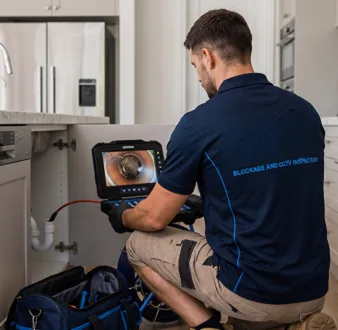Clearing a blocked sink at a Sydenham property